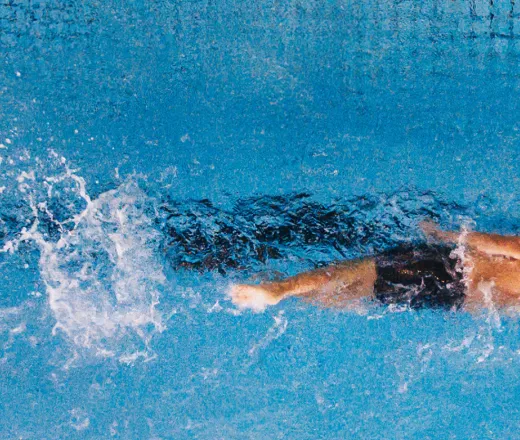 Man swimming laps from above