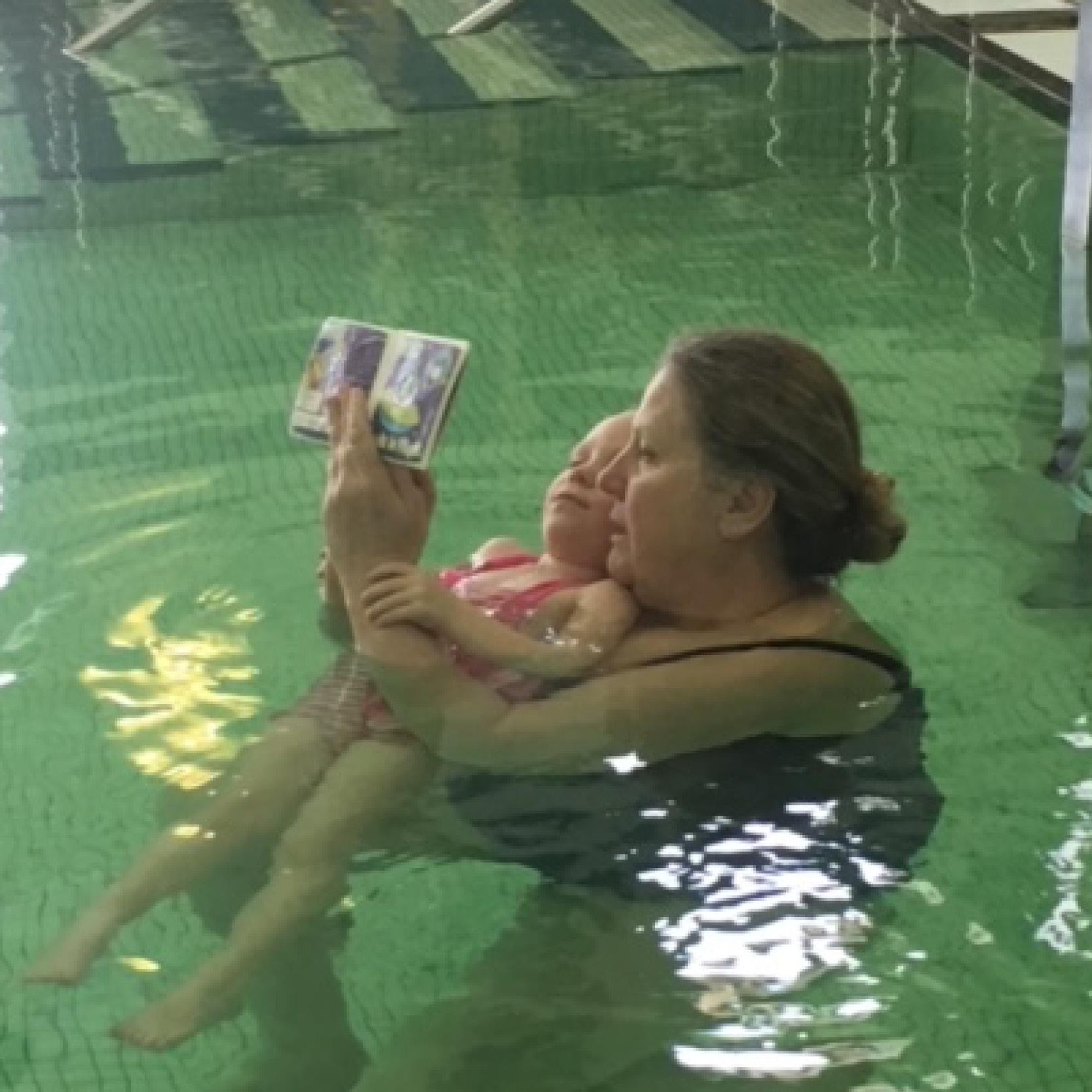 Image of a woman and baby swimming