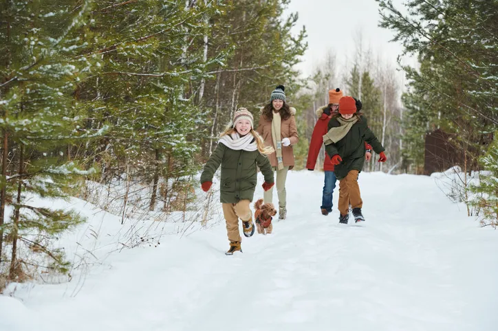 family walking in the snow