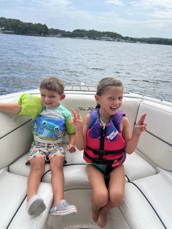 kids at the lake in a boat