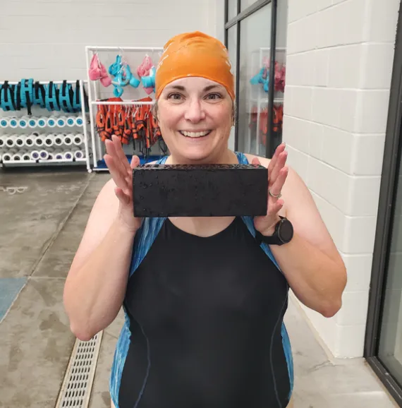 woman holding brick by the pool