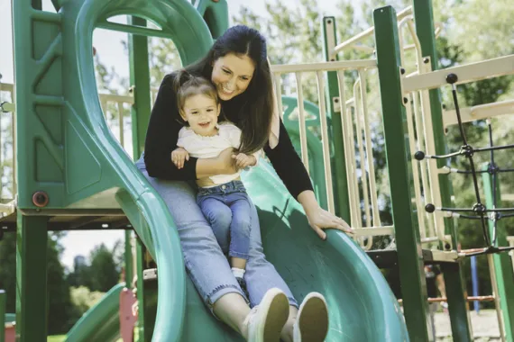 mom and daughter going down slide