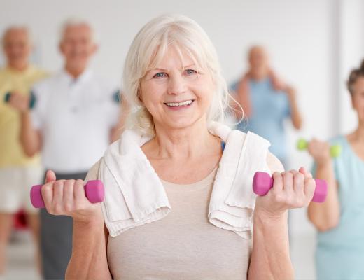 Active Older Adult with weights and towel