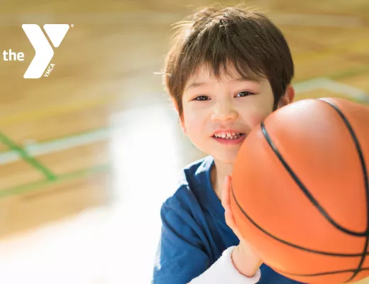 Toddler holding a basketball