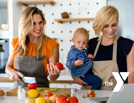 Family with baby making dinner