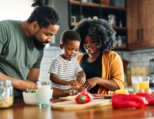 Family cooking dinner in kitchen