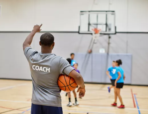 Image of man coaching youth basketball