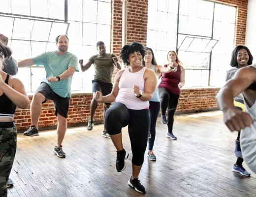 A group of young adults in a group fitness class