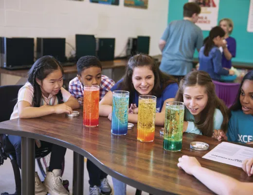 Kids doing a science experiment with their camp counselor