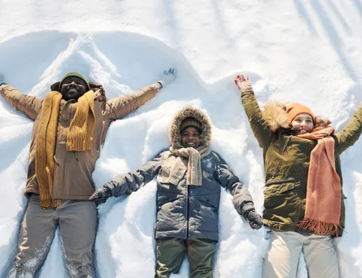 family making snow angels