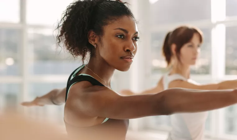 2 young women practicing yoga