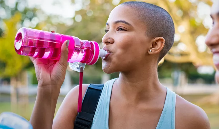 Young woman drinking from a water bottle