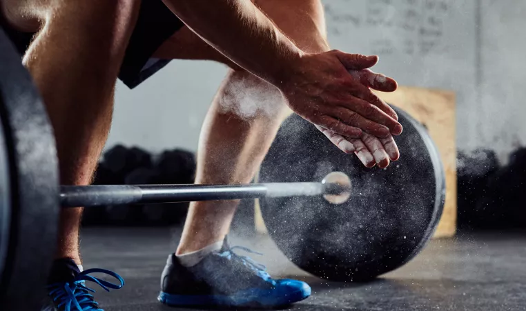 Image of a person's hands about to lift weights