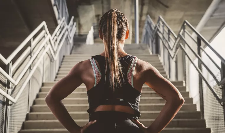 A woman preparing to run up the stairs