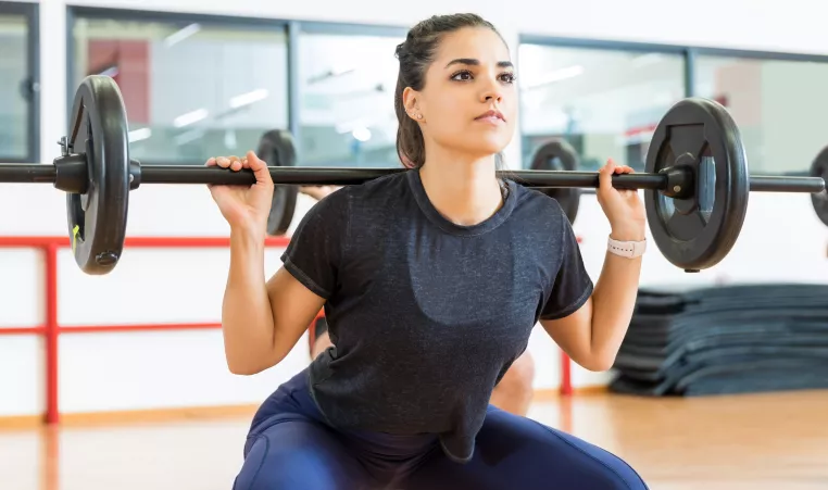 Women squatting with weights