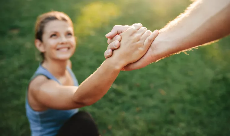 Image of a woman being helped up