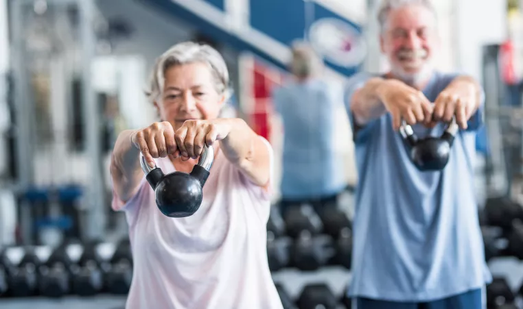 Seniors exercising with kettlebells