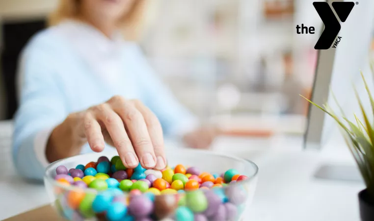 Woman eating candy at her desk