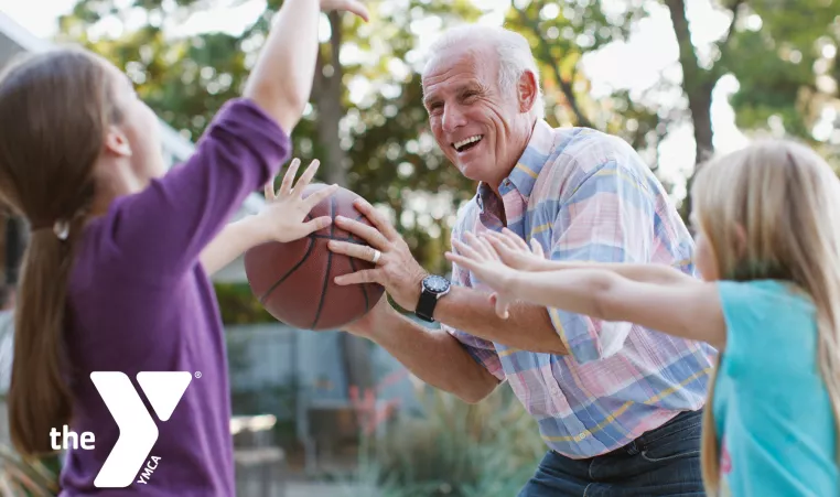 Grandpa playing basketball with grandkids