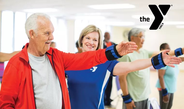 Trainer guiding an older man through exercises