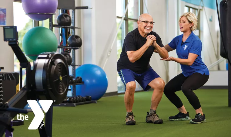 Senior man working out with a trainer