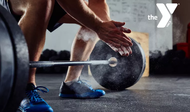 Close up of a man about to deadlift.