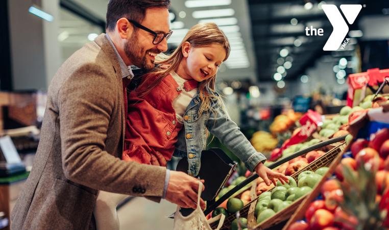 Image of a father and daughter shopping for fruits and veggies