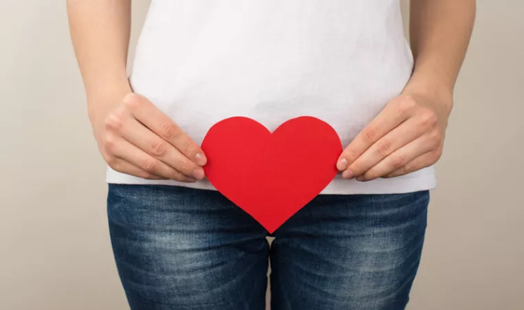 Image of a woman holding a paper heart