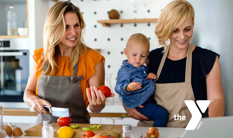 Family with baby making dinner