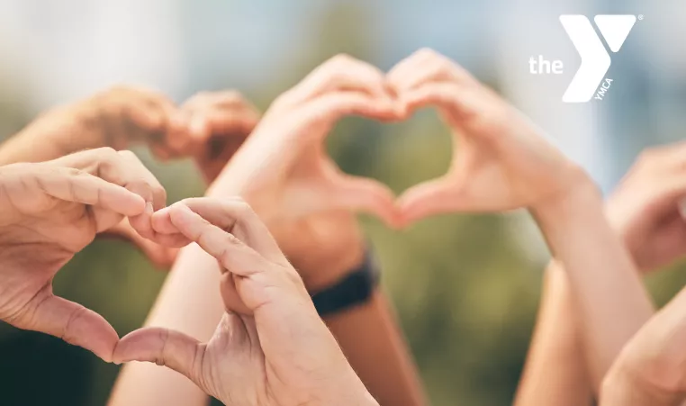 close up of hands forming a heart shape