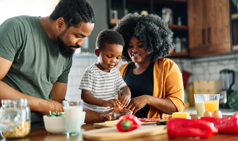 Family cooking dinner in kitchen