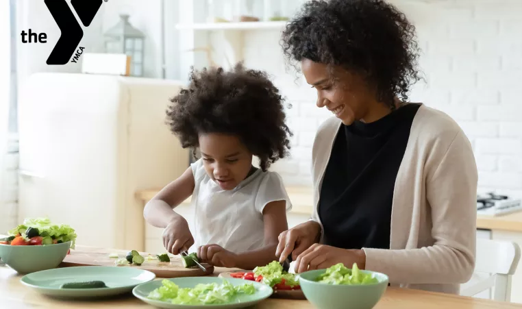 Mom and daughter preparing a healthy meal in a kitchen