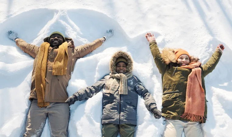 family making snow angels