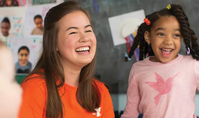 Child and teacher laughing