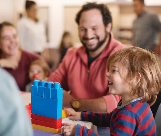Parent playing with child in classroom