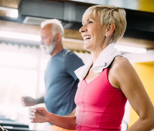 Senior couple running on treadmill