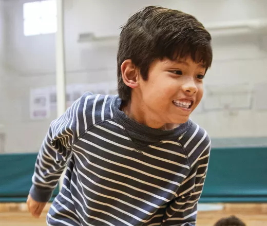 Youth member playing in the gym