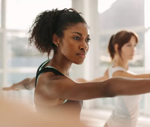 2 young women practicing yoga