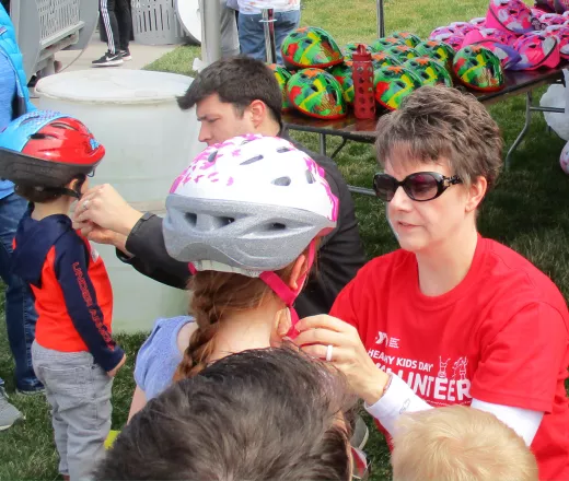 Child getting fitted for a bike helmet