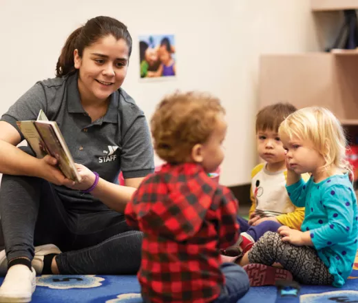 early learning teacher reading to toddlers