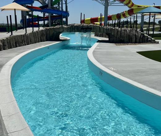 Water park lazy river, with water slides in the background