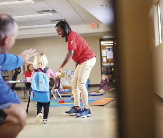 father waving at daughter going to school