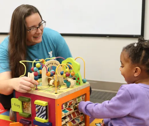 day care provider and child playing