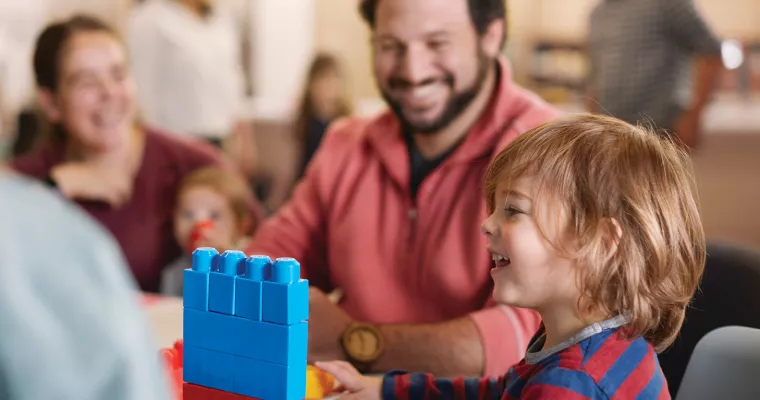 Parent playing with child in classroom