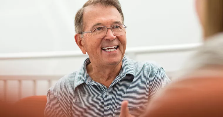 Older man leading a meeting