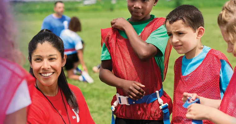 Youth sports coach talking to players