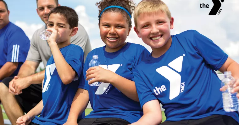 Kids sitting on a sports sideline