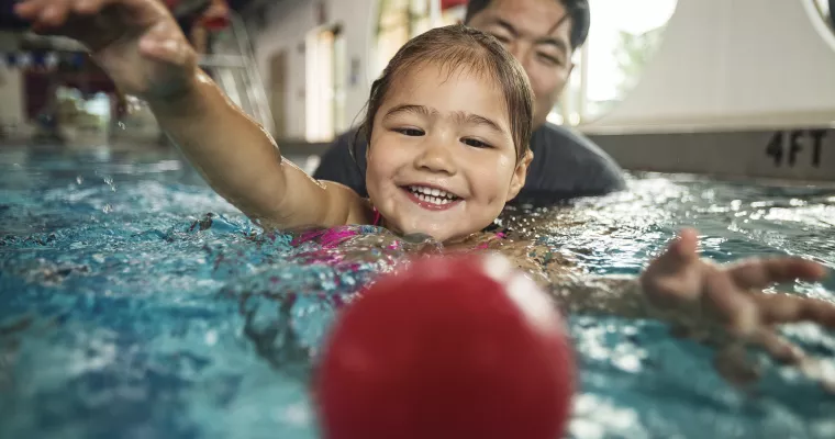 Father and daughter swimming together