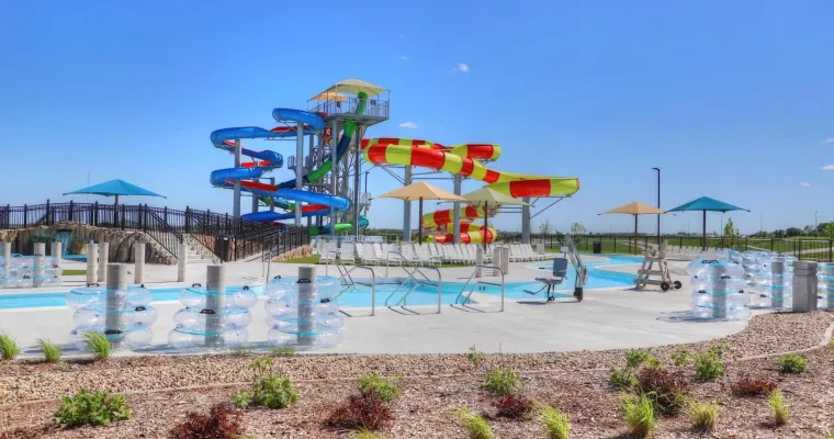 Image of a water park with tall water slides in the background.