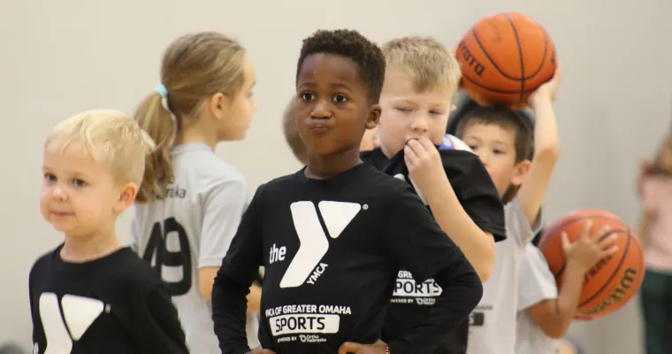A group of young kids playing basketball